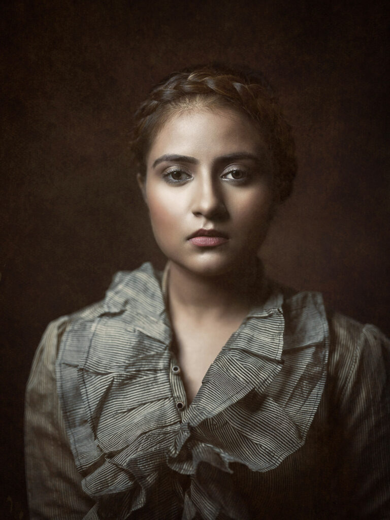 Legacy studio portrait of a young girl in Rembrandt style lighting and a Victorian look